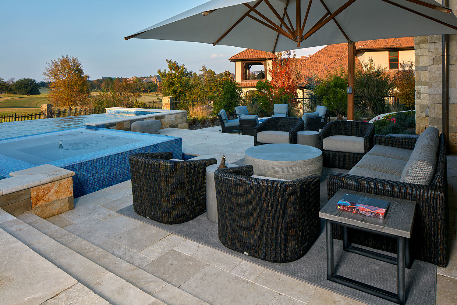 Poolside Seating Area with Barrel Chairs and Large Umbrella