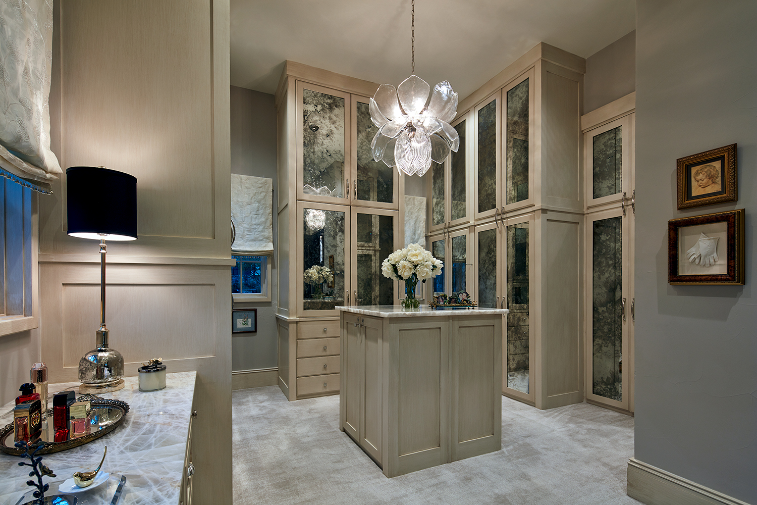 Expansive Woman's Closet with Vanity and Glass Front Custom Cabinets