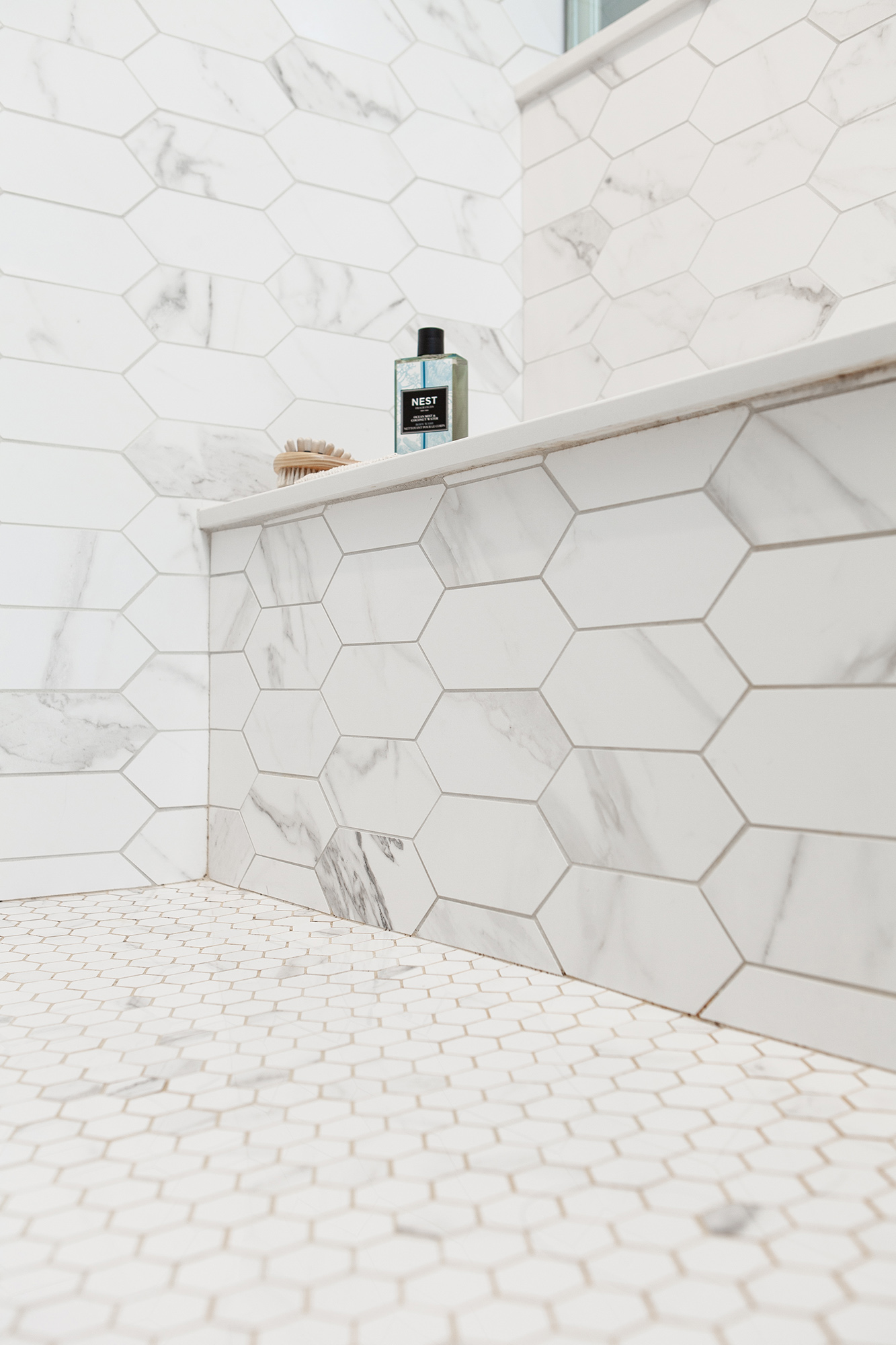 shower bench seat clad in hexagonal marble