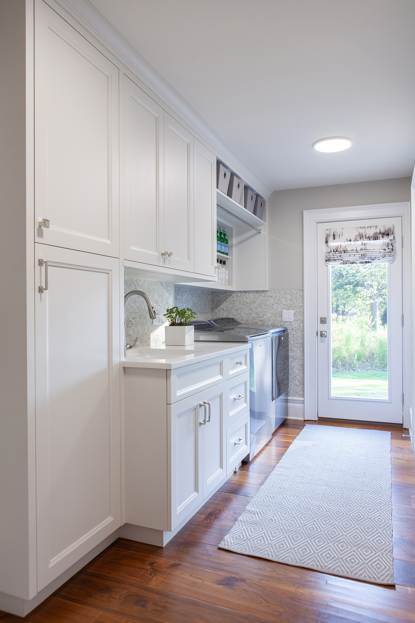 laundry room with white cabinetry