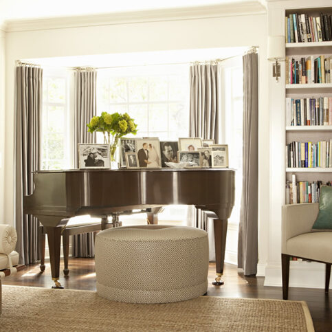formal library with baby grand piano in bump out